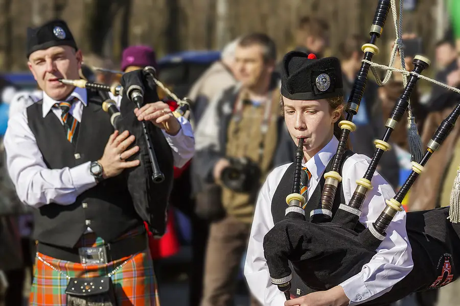 woman and man playing bagpipes on march