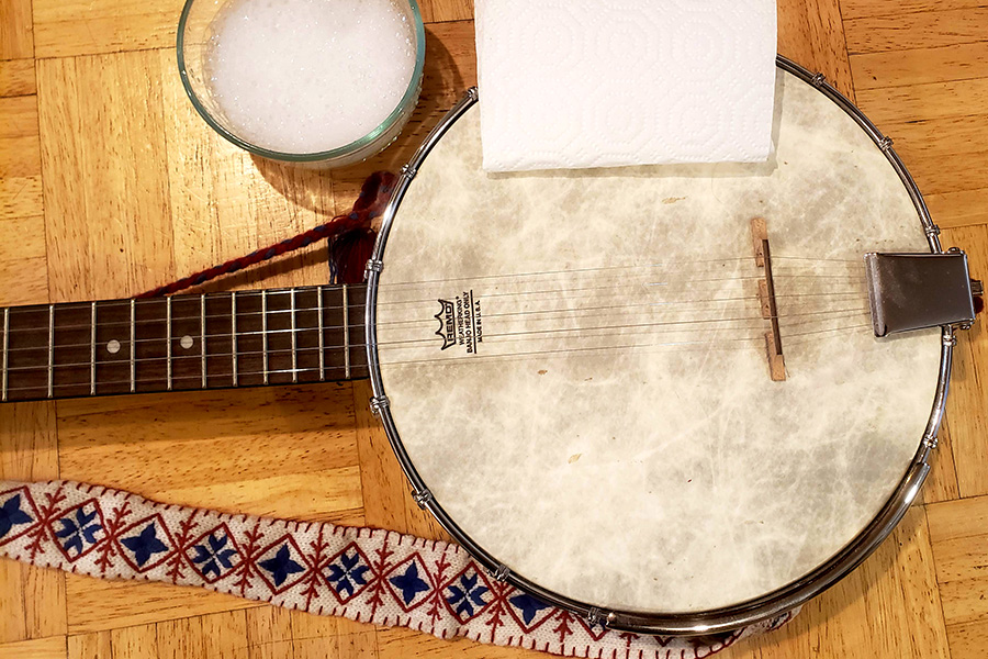 banjo focusing on banjo head, water and paper towel