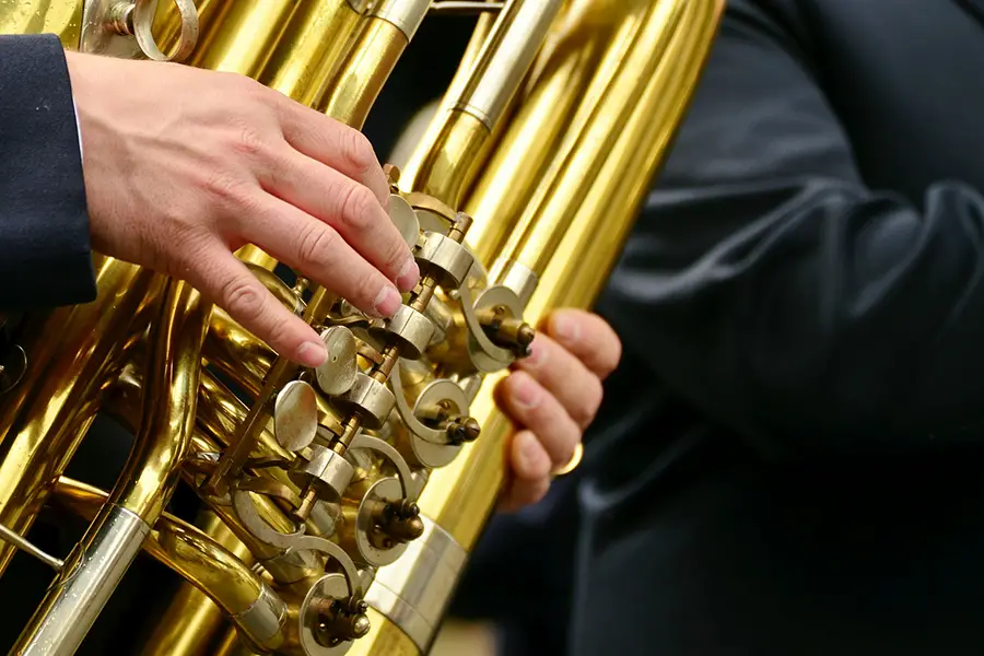 holding tuba showing valves