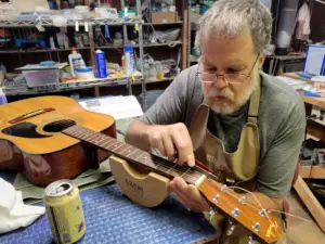 luthier working on guitar